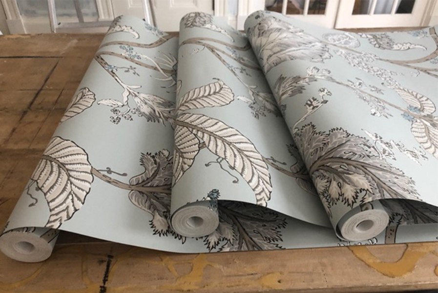 Rolls of patterned wallpaper ready for installation