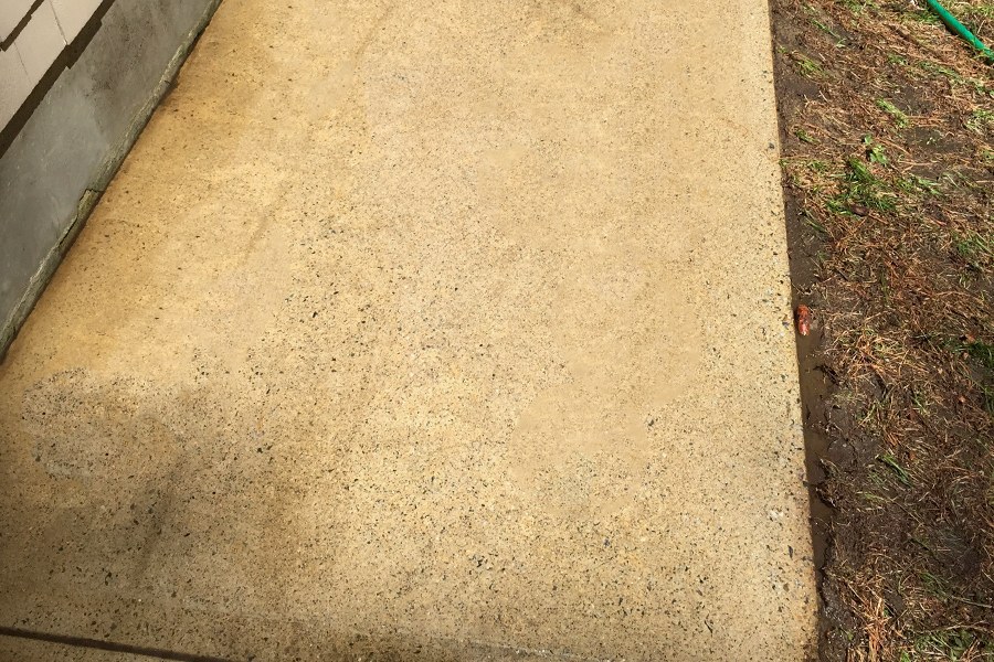 A freshly power washed concrete walkway