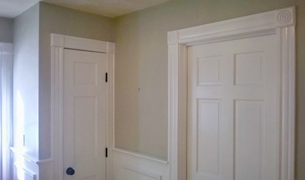 A freshly painted interior hallway with crisp white doors and trim
