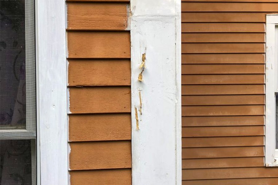Peeling paint and worn exterior trim in need of carpentry repair